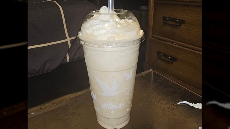 Wawa coffee milkshake sits on a glass table
