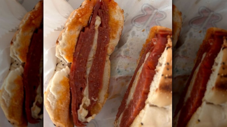 Wawa pepperoni bagel melt cut in half with pepperoni and cheese on an everything bagel