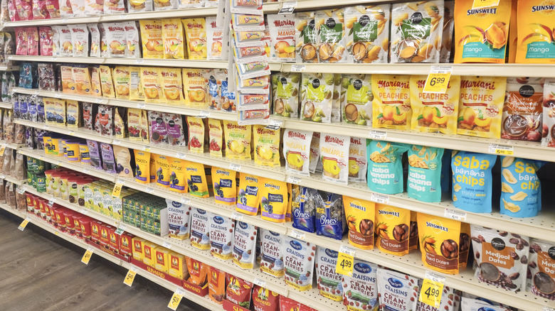 Grocery store aisle featuring snacks on shelves