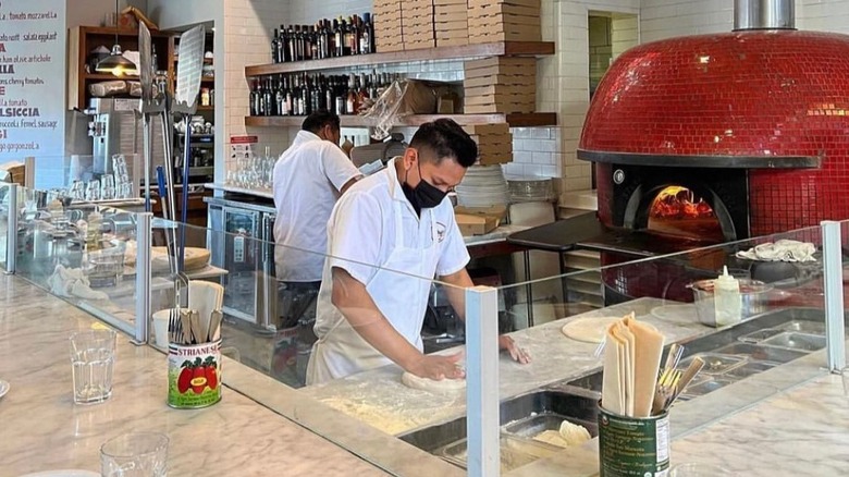 Pizzeria interior with red tiled oven