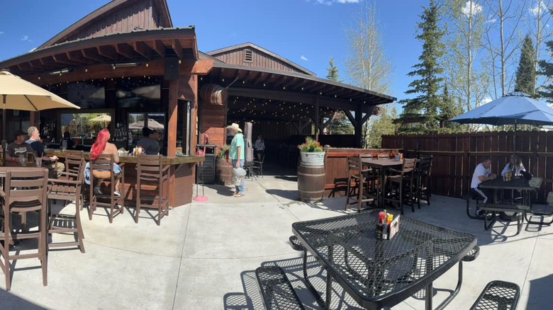 The Buffalo Bar exterior dining patio with customers tables and seating