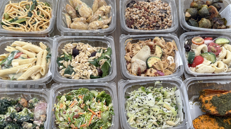 A variety of prepared foods from Whole Foods on wooden table