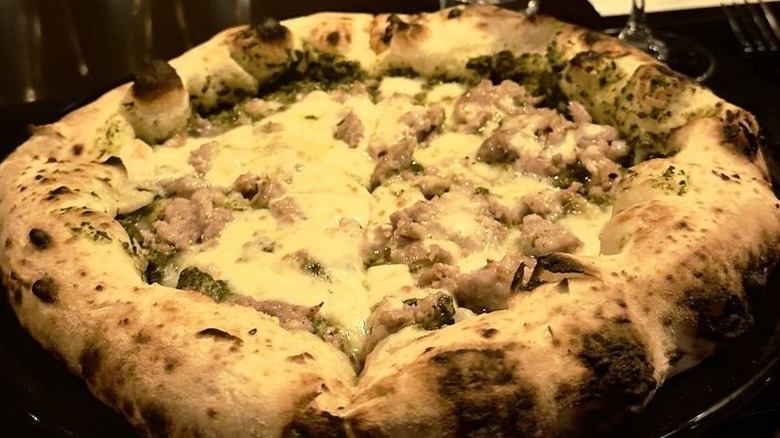 A whole Neapolitan-style pizza bianca topped with sausage