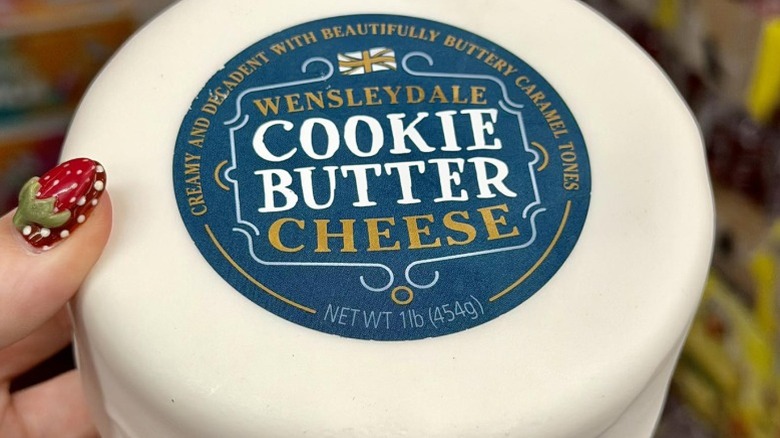 hand holding wheel of cookie butter cheese