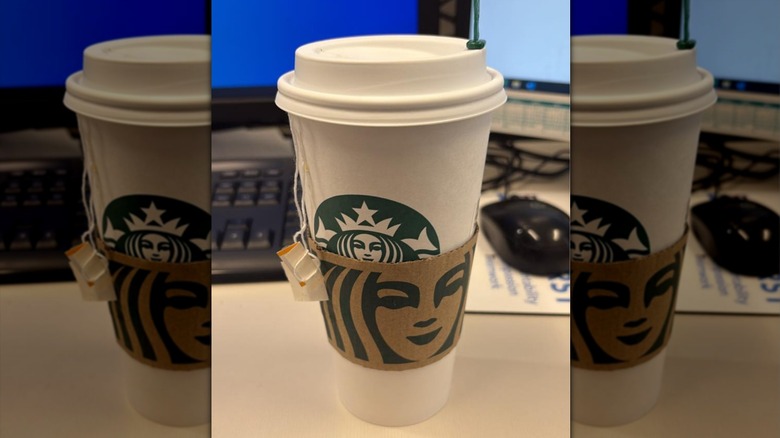 A Chamomile Mint Blossom Tea from Starbucks sits on a desk