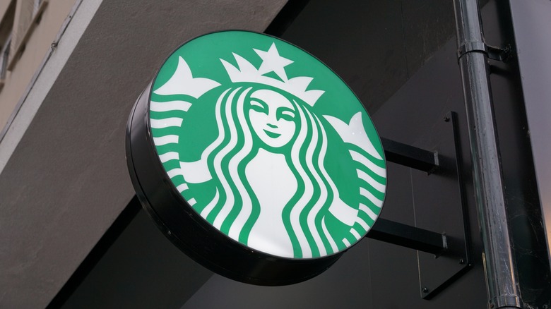 A Starbucks sign is seen outside a storefront