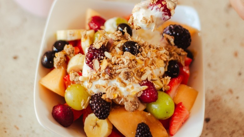 bowl of cereal, fruit, and yogurt