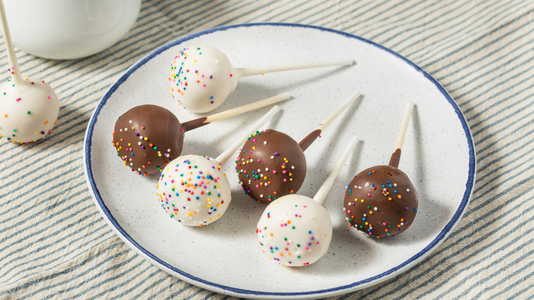 homemade cake pops on a white plate with a blue rim
