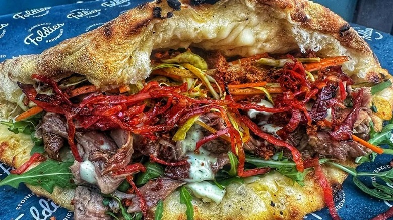 pizza sandwich filled with meat and vegetables