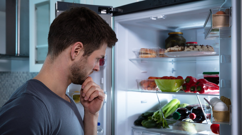 Man looking inside of fridge