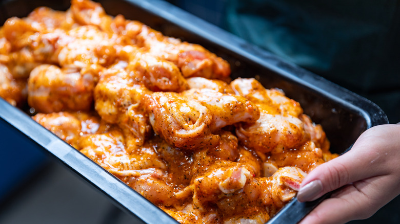 Marinading raw chicken in a tray
