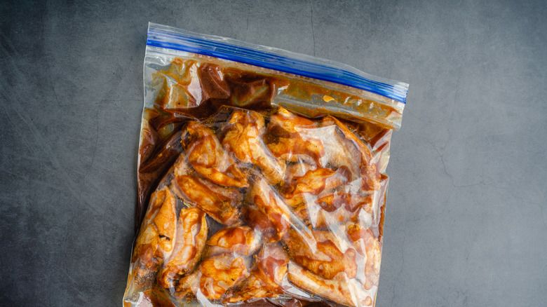 Chicken marinating in a sealed plastic bag