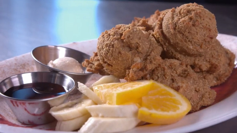 French toast puffs with oranges, bananas, and compote on a plate