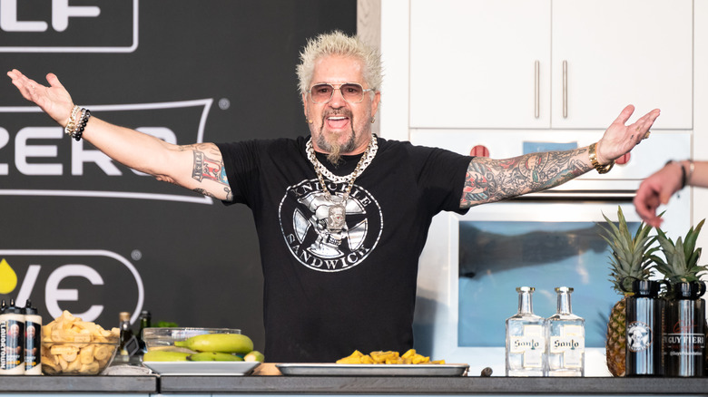 Guy Fieri on stage at a cooking demo