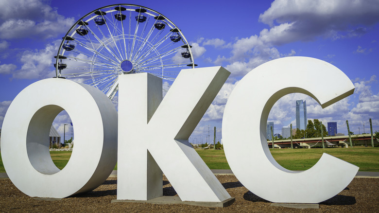 Giant 'OKC' sign in Oklahoma City with Ferris wheel in background, day