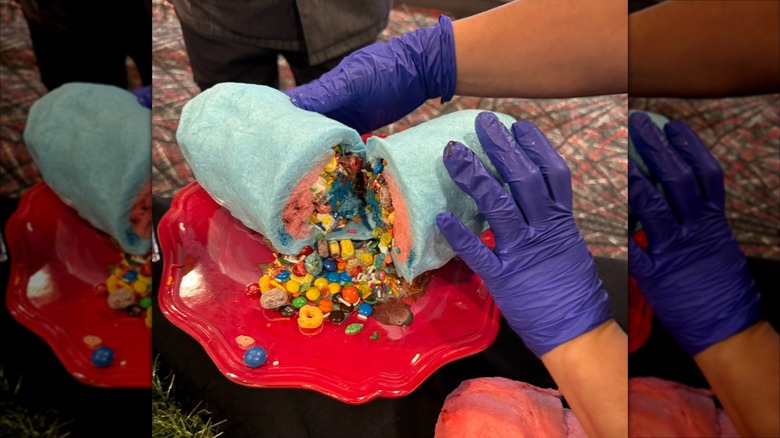 Gloved hands splitting a Cotton Candy Burrito, revealing candy inside