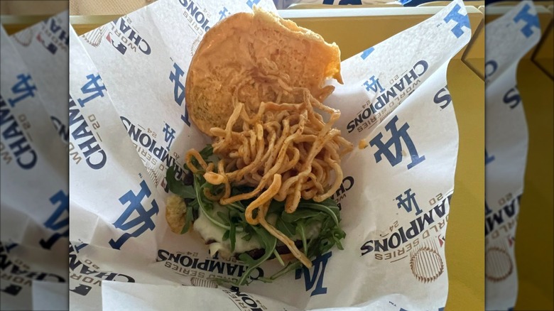 Ramen Burger in LA-branded paper, served open-face to show the toppings