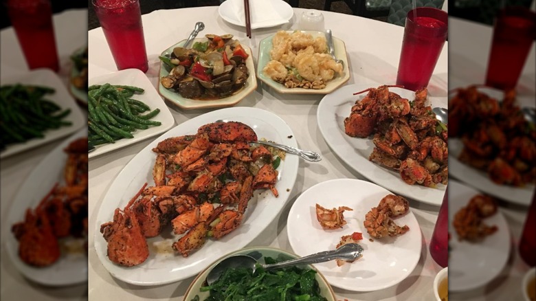 Platters of seafood and vegetables arranged on a large table.