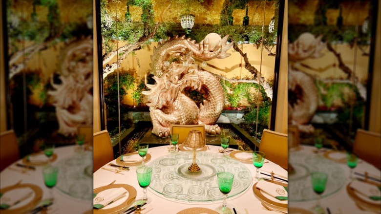 An elaborate gold and green dining area.