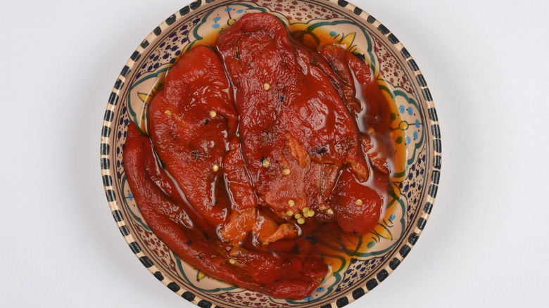 Roasted red Macedonian peppers in a decorative ceramic bowl