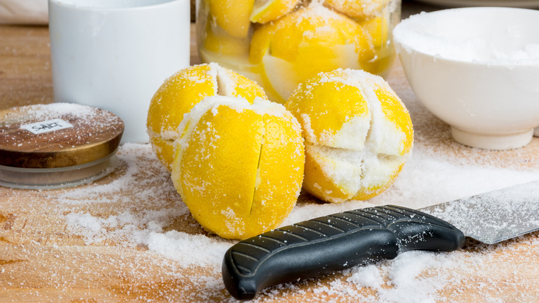 The tools for making preserved Moroccan lemon, lemons, salt, knife, container