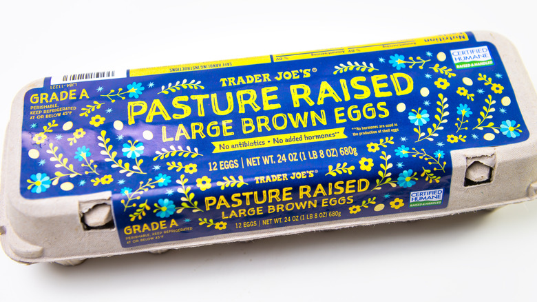 A carton of Trader Joe's pasture raised eggs isolated on a white background