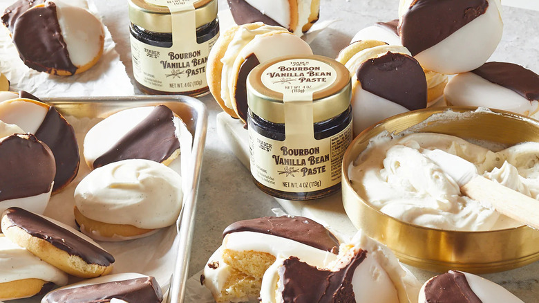 Jars of Trader Joe's Bourbon Vanilla Bean Paste surrounded by black-and-white cookies and frosting