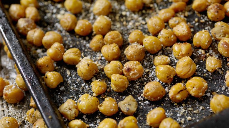 Crispy chickpeas on baking sheet with lots of flaky salt