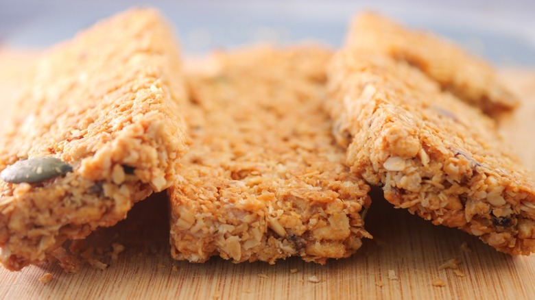 Healthy homemade granola bars displayed on a wooden board
