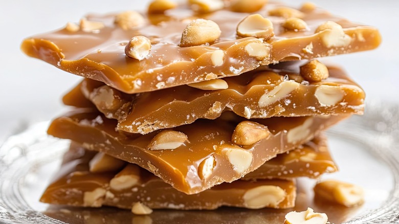 Close up of stack of peanut brittle on silver plate