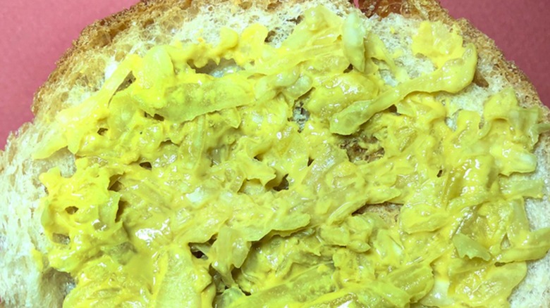 homemade vegan sauerkraut cheese spread on piece of white bread