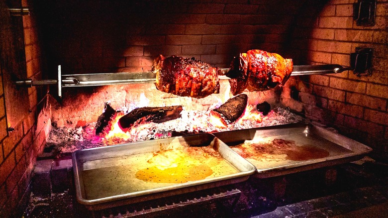 Meat roasting on a spit over an open flame at Kokkari Estiatorio restaurant.
