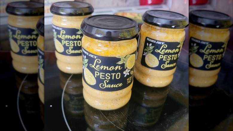 three jars of trader joe's lemon pesto sauce on stovetop