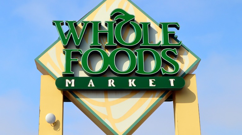 Whole Foods sign. Yellow diamond-shaped sign with Whole Foods Market in green lettering