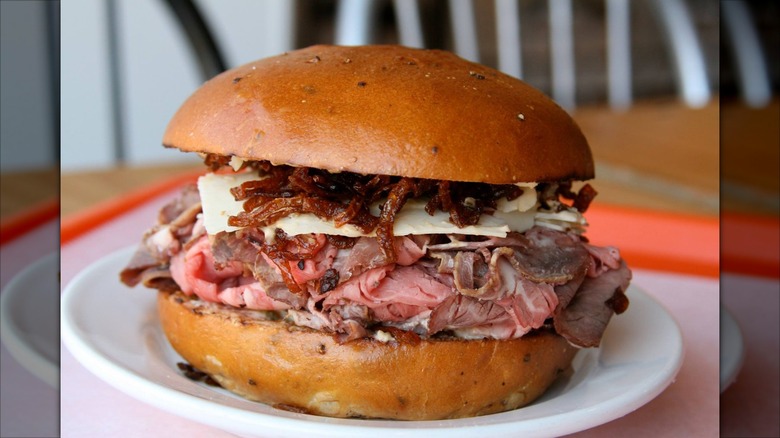 Sliced meat sandwich on a bun