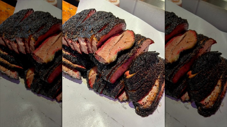 Sliced brisket on white parchment paper
