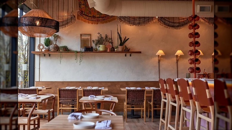 Alma Fonda Fina's Mexican-inspired dining room with wooden tables and chairs