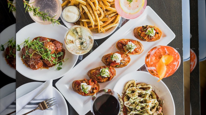 Several dishes on table including meatballs and bruschetta