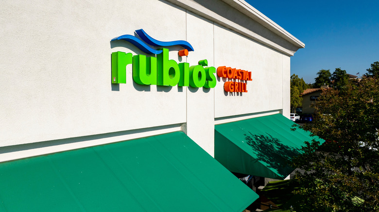 Rubio's Coastal Grill restaurant exterior with green awnings on day with bright blue sky