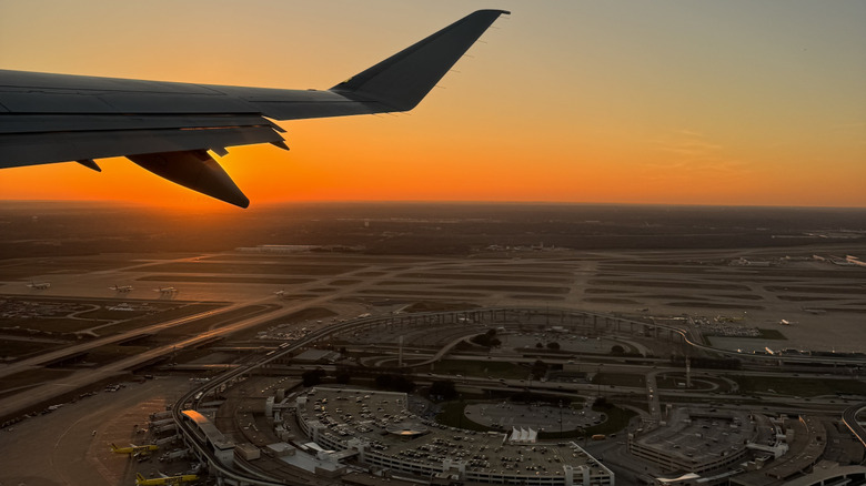 View from plane taking off from Dallas Fort Worth International Airport at sunset