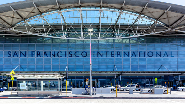 Cars pull up to the San Francisco International Airport sign at airport entrance