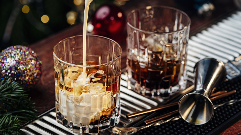 Cream pouring into a glass with ice to make a white Russian