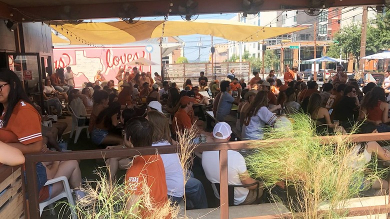 Busy game day at Cain and Abel's outdoor patio with many customers