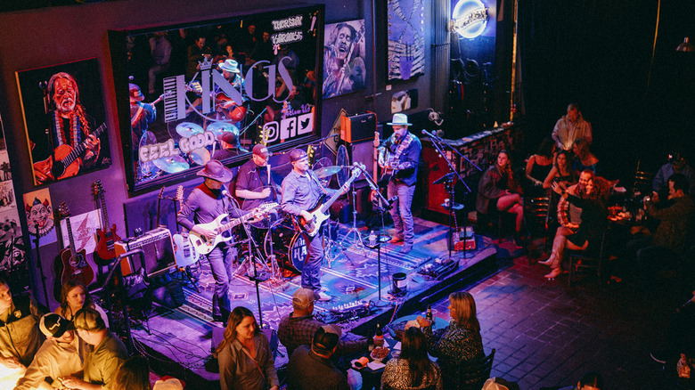Interior of Kings Live Music with a band playing on stage and bar patrons milling about