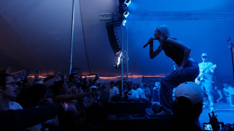 Interior of Fred's in Tigerland featuring a band on stage, female lead singing into the crowd