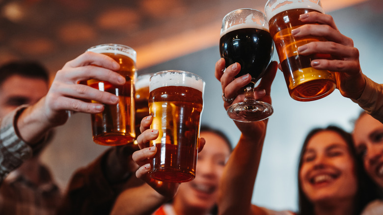 Friends raising a toast with glasses of beer
