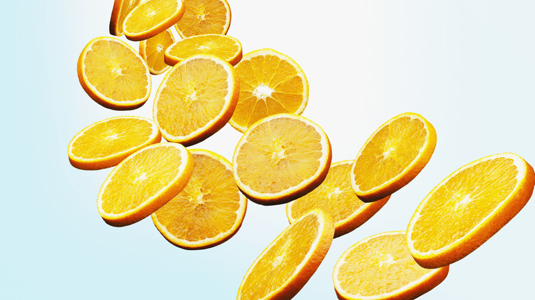 A line of orange slices falling toward the camera