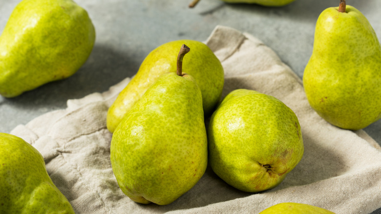 green pears sitting atop a cloth napkin