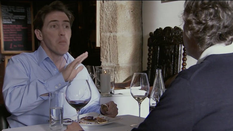 Steve Coogan and Rob Brydon drinking wine and eating a meal in "The Trip"