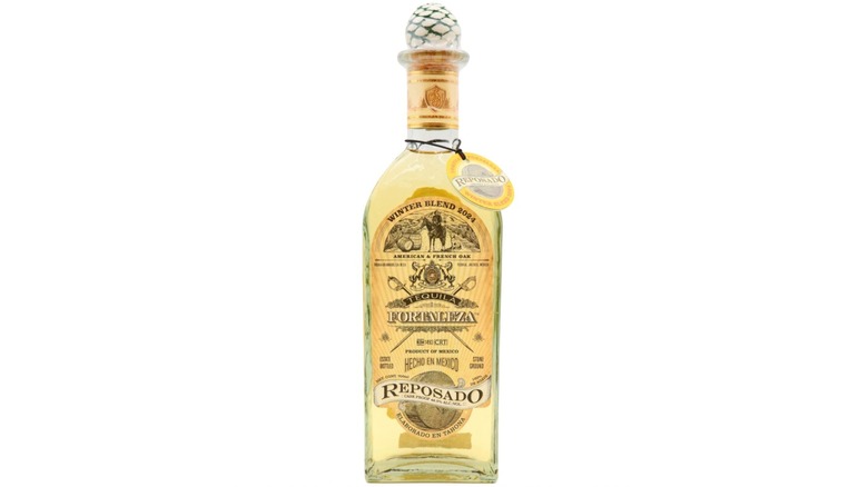 Bottle of Fortaleza Winter Blend tequila on white background.